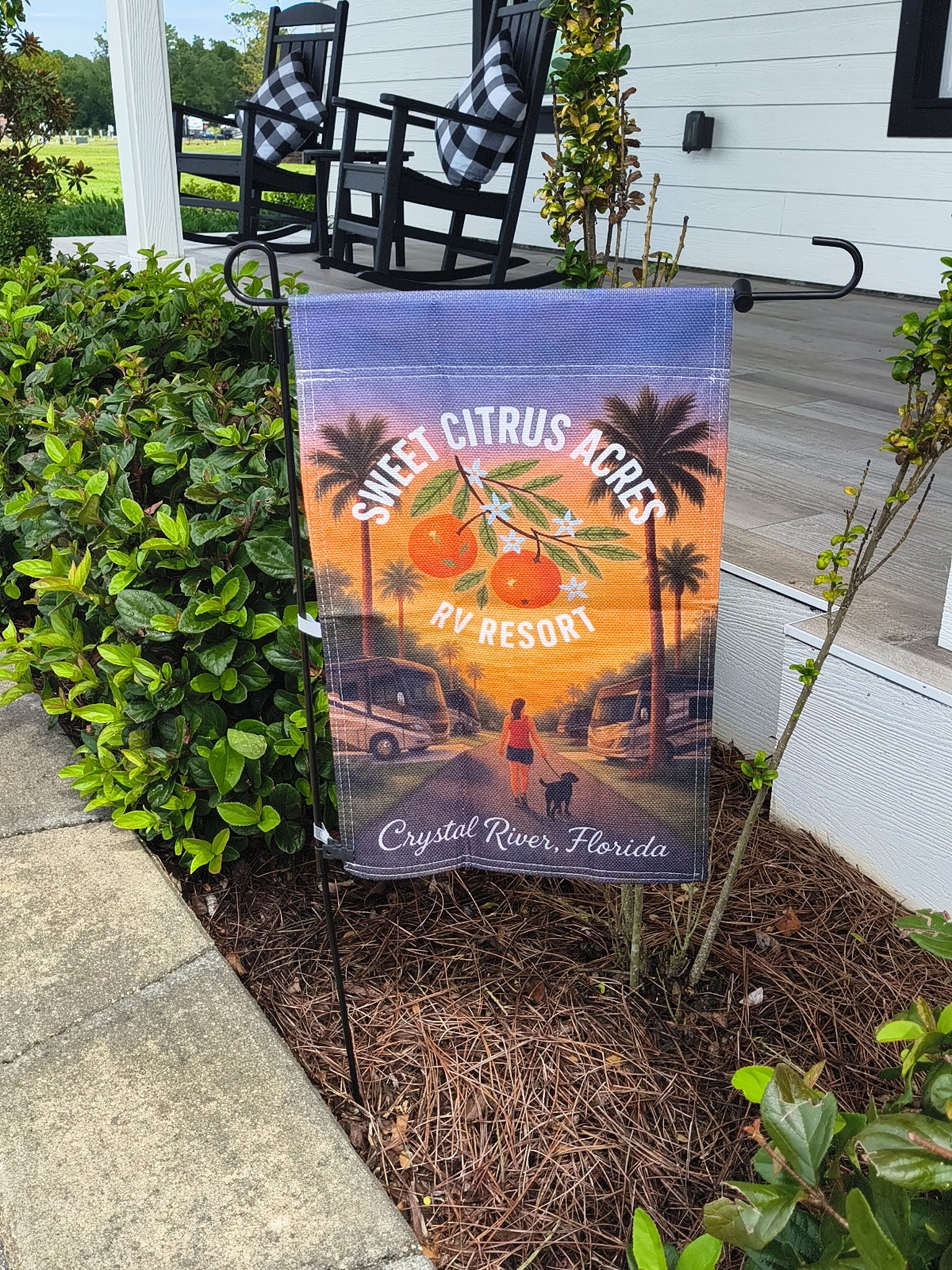 Sweet Citrus Acres RV Resort woman walking dog flag – Crystal River Florida resort pet-friendly décor